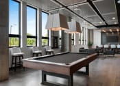 Thumbnail 12 of 53 - a view of the clubhouse with a pool table in the foreground and tables and chairs in the